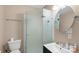 Bathroom featuring a glass shower stall, a round mirror, and a modern vanity at 9029 J M Keynes Dr # 63, Charlotte, NC 28262