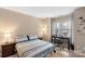 Comfortable bedroom featuring a workspace and a large window with natural light at 9029 J M Keynes Dr # 63, Charlotte, NC 28262