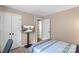 Cozy bedroom features neutral walls, a striped bedspread, and a flatscreen TV on a stand at 9029 J M Keynes Dr # 63, Charlotte, NC 28262