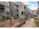 Multi-story condo building showing the exterior facade with landscaping in a central courtyard at 9029 J M Keynes Dr # 63, Charlotte, NC 28262