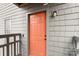 Front entry door featuring a unit number and light fixture with neutral-colored siding at 9029 J M Keynes Dr # 63, Charlotte, NC 28262