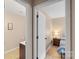 Hallway view to a bathroom with a vanity and to a bedroom featuring a bed at 9029 J M Keynes Dr # 63, Charlotte, NC 28262