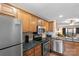 Kitchen featuring stainless steel appliances, wood cabinets, and granite counters at 9029 J M Keynes Dr # 63, Charlotte, NC 28262
