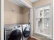 Convenient laundry area with side-by-side Samsung washer and dryer and a bright window at 9029 J M Keynes Dr # 63, Charlotte, NC 28262
