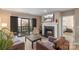 Cozy living room featuring a fireplace and sliding glass doors to a balcony with seating at 9029 J M Keynes Dr # 63, Charlotte, NC 28262