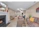 Open concept living room with hardwood floors, fireplace and a view of the dining area at 9029 J M Keynes Dr # 63, Charlotte, NC 28262