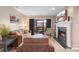 Cozy living room with fireplace and balcony access, perfect for relaxing and entertaining at 9029 J M Keynes Dr # 63, Charlotte, NC 28262