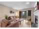Comfortable living room featuring a balcony, offering a seamless indoor-outdoor living experience at 9029 J M Keynes Dr # 63, Charlotte, NC 28262