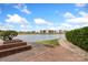 Picturesque view of pond and surrounding community buildings with blue skies and greenery at 9029 J M Keynes Dr # 63, Charlotte, NC 28262