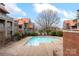 A refreshing community pool with elegant surroundings and a view of the building's exterior at 9029 J M Keynes Dr # 63, Charlotte, NC 28262