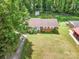 A charming brick home with a lush green lawn and mature trees at 907 E 9Th Ave, Gastonia, NC 28054