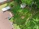 Aerial view of a house, shed and backyard with abundant green space, surrounded by mature trees at 907 E 9Th Ave, Gastonia, NC 28054