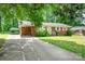 A well kept brick home with a lengthy driveway and lush green lawn at 907 E 9Th Ave, Gastonia, NC 28054