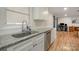 Granite countertops, stainless steel dishwasher and fixtures featured in this modernized kitchen at 907 E 9Th Ave, Gastonia, NC 28054