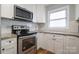 Kitchen features stainless steel appliances, granite countertops, and updated fixtures at 907 E 9Th Ave, Gastonia, NC 28054