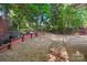 Spacious backyard showcasing wooden raised garden beds with potted plants, and tree coverage at 9200 Forest Green Dr, Charlotte, NC 28227