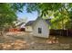 View of the home's backyard with an additional building, brown fence and tree coverage at 9200 Forest Green Dr, Charlotte, NC 28227