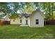 Picturesque backyard with white home, patio, and well-maintained grass lawn at 9200 Forest Green Dr, Charlotte, NC 28227