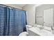 Bathroom with blue shower curtain, gray vanity, and white walls at 9200 Forest Green Dr, Charlotte, NC 28227