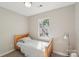Bedroom with a neutral color scheme features a bright window at 9200 Forest Green Dr, Charlotte, NC 28227