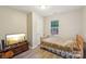 Bedroom with wood-look floors and bright window next to bed at 9200 Forest Green Dr, Charlotte, NC 28227
