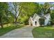 Charming home showcasing a curved driveway, lush lawn, and delightful curb appeal at 9200 Forest Green Dr, Charlotte, NC 28227