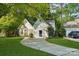 Inviting home with curved driveway, lush lawn, and picturesque landscaping at 9200 Forest Green Dr, Charlotte, NC 28227
