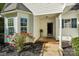 Home exterior with a welcoming front porch and blooming roses at 9200 Forest Green Dr, Charlotte, NC 28227