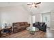 Bright living room with wood flooring, ceiling fan, and comfortable seating at 9200 Forest Green Dr, Charlotte, NC 28227