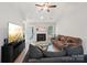 Cozy living room with fireplace, wood floors, and ample seating at 9200 Forest Green Dr, Charlotte, NC 28227