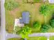 Aerial view of a home with a dark roof, and lush green lawn, surrounded by mature trees at 1009 Rainbow Cir, Catawba, SC 29704