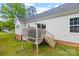 Back exterior of home with a small deck and stairs, siding, and a well-maintained lawn at 1009 Rainbow Cir, Catawba, SC 29704