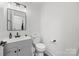 Updated bathroom features a sleek vanity, sink and toilet at 1009 Rainbow Cir, Catawba, SC 29704