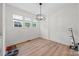Bright dining room boasts modern light fixture, new flooring, and large windows at 1009 Rainbow Cir, Catawba, SC 29704