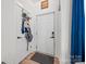 Inviting entryway with coat rack, wood floors, and white door at 1009 Rainbow Cir, Catawba, SC 29704
