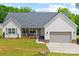 Charming single Gathering home with a well manicured front lawn, driveway, and integrated garage at 1009 Rainbow Cir, Catawba, SC 29704