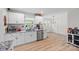 Well-lit kitchen with white cabinets, stainless appliances and access to dining area at 1009 Rainbow Cir, Catawba, SC 29704