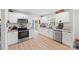 Modern kitchen with white cabinetry, stainless steel appliances, and granite countertops at 1009 Rainbow Cir, Catawba, SC 29704