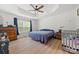 Spacious main bedroom featuring tray ceiling, large window, and wood-look floors at 1009 Rainbow Cir, Catawba, SC 29704