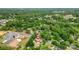 An aerial view displays a home located near commercial areas and surrounded by trees at 105 N Baldwin Ave, Kannapolis, NC 28083