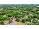 An aerial view presents a home surrounded by trees in a peaceful neighborhood at 105 N Baldwin Ave, Kannapolis, NC 28083
