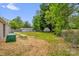Large partially-fenced backyard with lush grass and mature trees, perfect for outdoor activities at 105 N Baldwin Ave, Kannapolis, NC 28083