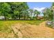Large backyard featuring lush grass and mature trees, perfect for outdoor activities and relaxation at 105 N Baldwin Ave, Kannapolis, NC 28083