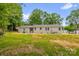Side and rear view of a home with a spacious backyard and mature trees at 105 N Baldwin Ave, Kannapolis, NC 28083