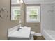 Bathroom featuring a white vanity with marble countertop, toilet, and combined tub and shower at 105 N Baldwin Ave, Kannapolis, NC 28083