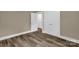 Bedroom with hardwood floors, white trim, and two white doors that allow access to other rooms at 105 N Baldwin Ave, Kannapolis, NC 28083
