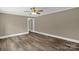 Bedroom with hardwood floors, white trim, and an entry to another room that creates open space at 105 N Baldwin Ave, Kannapolis, NC 28083