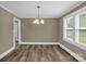 Dining area with hardwood floors, modern lighting, and two windows that allow plenty of natural light at 105 N Baldwin Ave, Kannapolis, NC 28083