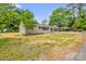 A charming home with neutral paint, dark shutters, well-maintained lawn and convenient covered parking at 105 N Baldwin Ave, Kannapolis, NC 28083