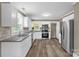 Bright, updated kitchen featuring white cabinets, granite counters, stainless appliances, and hardwood floors at 105 N Baldwin Ave, Kannapolis, NC 28083